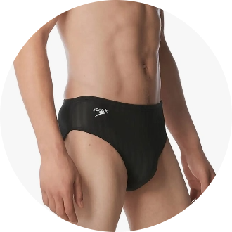 Man wearing black swim briefs with a logo on the hip. The product is designed for competitive swimming, providing comfort and performance in the water.